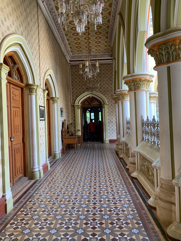 Image shows a corridor of Bangalore Palace