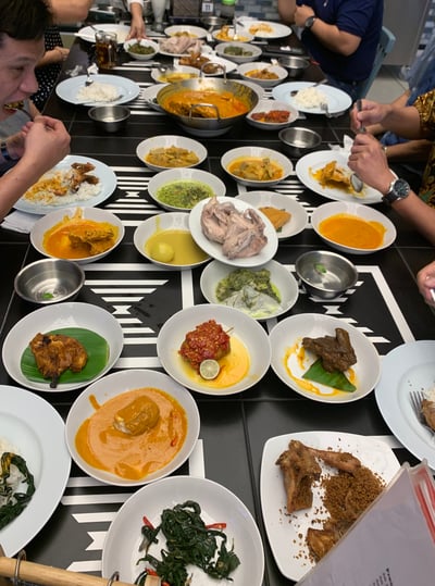 Image shows an Indonesian feast featuring an array of traditional dishes