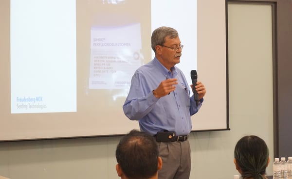 Image shows Freudenberg-NOK Director in Technology, Dr. Robert W. Keller delivering a presentation