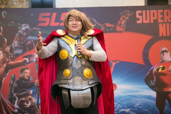 Image shows SLS Group CEO Mr. Roy Tan dressed as Thor, delivering his opening speech