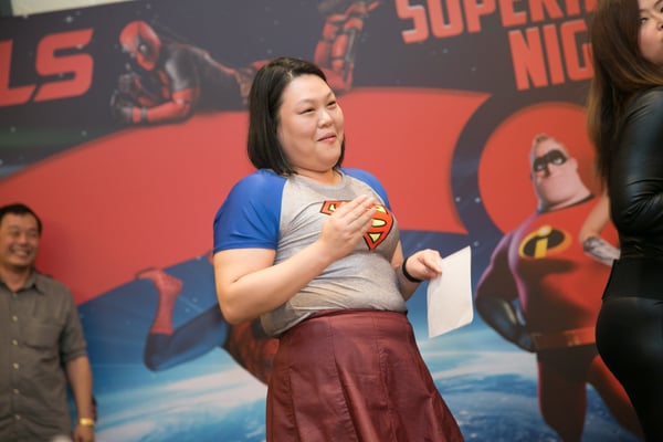 Image shows a woman dressed in a Superman tee 