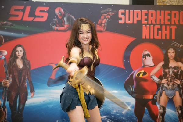 Image shows a woman dressed as Wonder Woman on stage