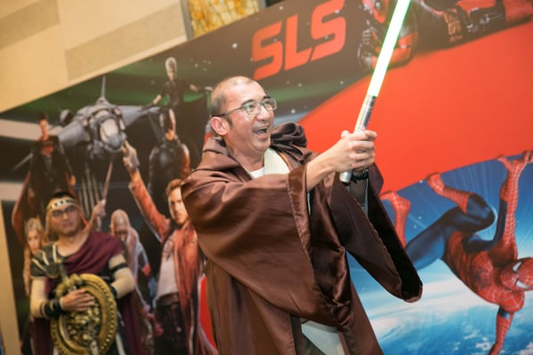 Image shows a man with a lightsaber dressed as a Jedi
