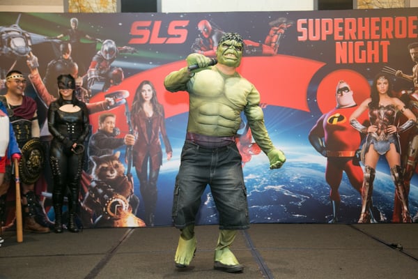 Image shows a man dressed as Hulk on stage