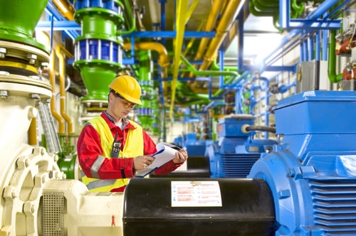 Image shows a service engineer inspecting a gear motor