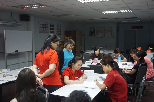 Image shows employees engaging in a role-play session