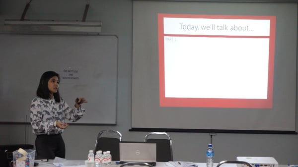 Image shows trainer, Ms Sabrina Quek delivering a presentation on service excellence