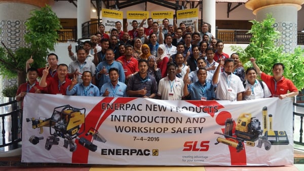 Image shows a group photo consisting of SLS staff and customers holding a banner that says: Enerpac New Products Introduction and Workshop Safety 7-4-2016