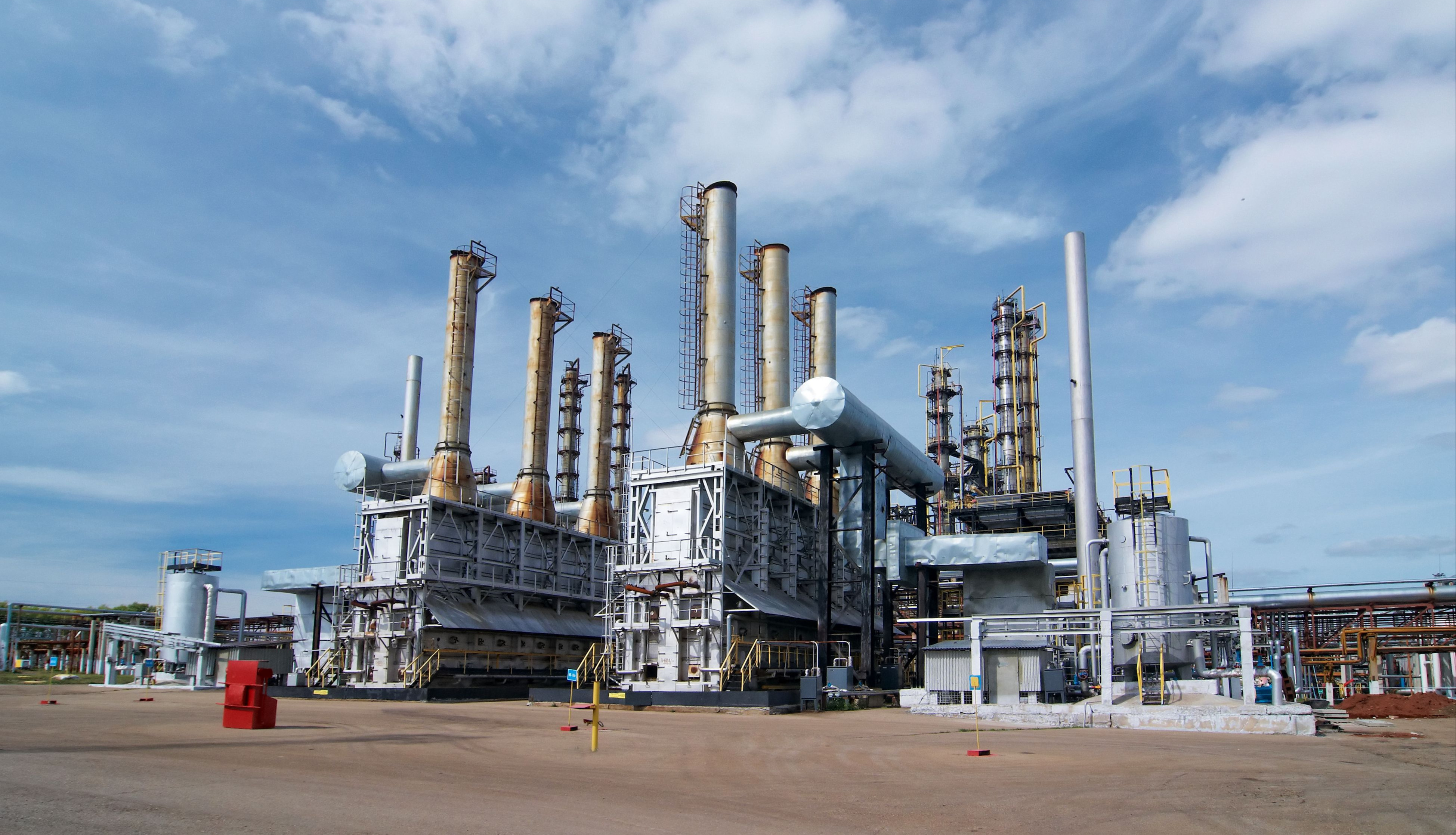 Image shows a petrochemical plant and a clear blue sky