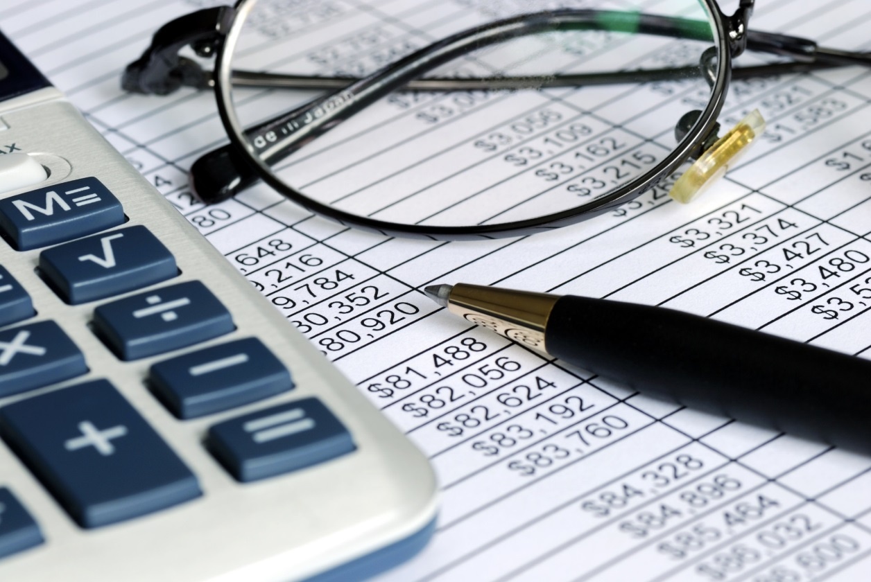 Image showing a spreadsheet with a calculator, glasses and pen